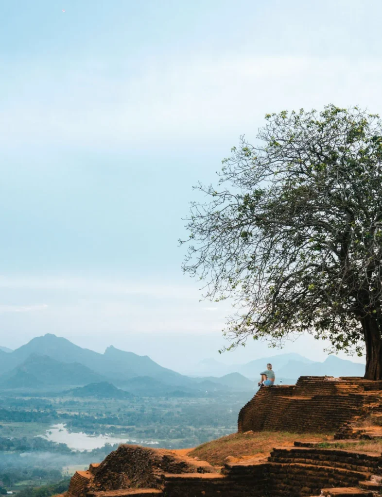 man-sitting-on-top-of-sigiriya-fortress-sri-lanka